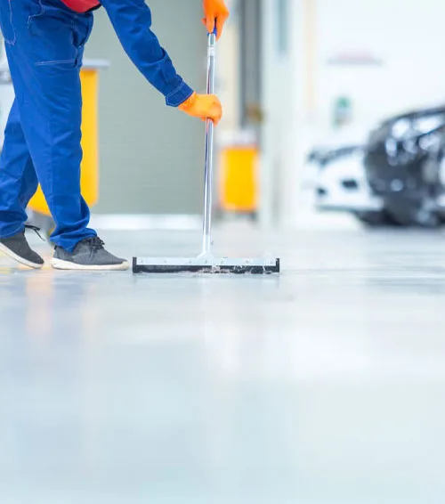 Squeegeeing a polished service-bay floor